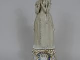 a statue of a woman standing on top of a table