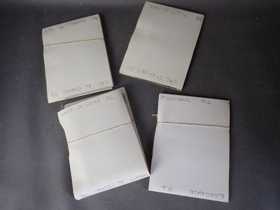 four pieces of white paper sitting on top of a table