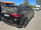 the rear end of a black mercedes suv parked in a parking lot