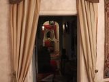 a doorway leading to a living room with a couch and a chair
