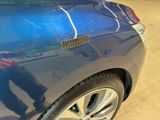 a close up of a blue car with a sticker on it