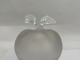a glass apple with a leaf on top of it