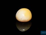 a white egg sitting on top of a black surface