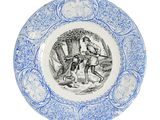 an old blue and white plate with a picture of a man riding a horse