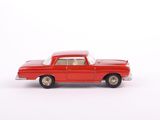 red toy car on a white surface with a white background