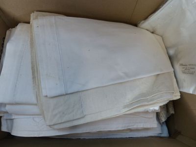 a lot of white sheets in a box on the floor