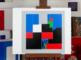 a picture of a painting on a easel in a room