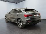 the rear end of a grey audi qx parked in a garage