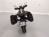 a motorcycle that is parked in a room with a license plate on it