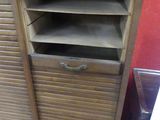 a wooden cabinet with drawers and a shelf on top of it