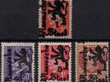 four different stamps with a lion on them on a black surface