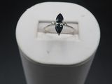 a close up of a ring in a white box on a black background