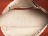 a brown and red bag with a tan interior