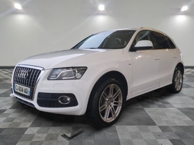the white audi suv is parked on a checkered tile floor