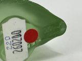 a green bottle with a red dot on it