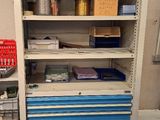a blue and white cabinet in a room with a red floor