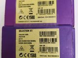 two purple boxes with labels on them sitting on a white surface
