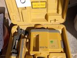 a yellow tool box with tools in it on the ground