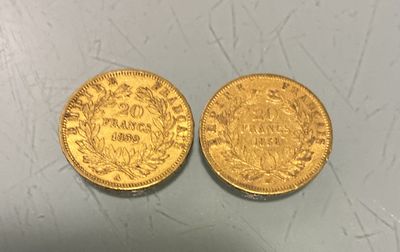 two pieces of gold coins sitting on top of a table