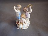 a figurine of two cherenshes on a shell