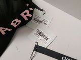 a black hat with a pink logo on it