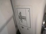 a close up of a white refrigerator with a label on it