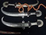 three different types of knives on a black surface