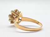an image of a yellow gold ring with a diamond center