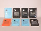 several books are lined up in a row on a table