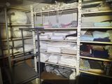 a room filled with lots of white sheets and blankets