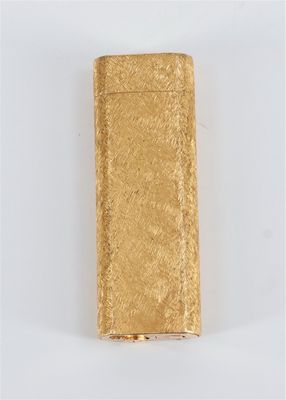 a gold cigarette case sitting on top of a white surface