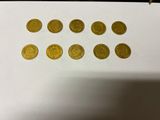 a close up of a piece of paper with gold coins on it