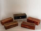 four wooden boxes with writing on them sitting on a white surface