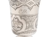 a silver cup that is sitting on a table