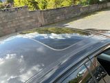 a reflection of the sky on the roof of a car