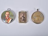 three different types of medals are displayed on a white surface