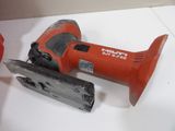 a red corded nail gun and a nail grinder on a table