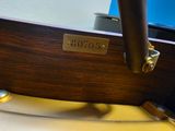 a close up of a wooden table with a clock on it