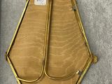 an image of a gold purse hanging on a wall