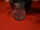 a close up of a bottle of wine on a red cloth