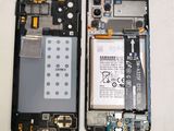 the back of a cell phone with a broken battery and a broken battery