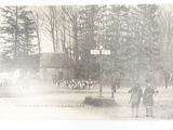 a black and white photo of a group of people riding horses
