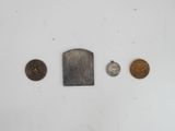 an assortment of coins and a knife on a white surface