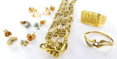 a lot of gold jewelry on a white surface