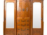 une grande armoire en bois surmontée d'un miroir