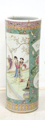 a vase with a painting on it sitting on a table