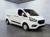 the white van is parked in the large room of the building