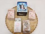 four boxes of soap sitting on top of a wicker tray