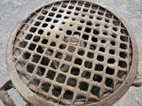 a person standing in front of a grate with yellow shoes