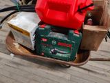 a cart with a red can and a green can on it